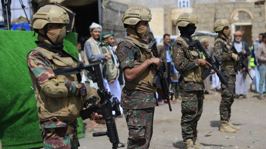 Members of Houthi security forces stand guard while supporters of Yemen's Houthi movement attend an event commemorating the ninth anniversary of the Saudi-led intervention in their country, in the capital, Sanaa, on March 26, 2026. 