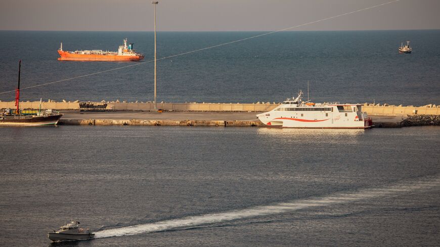 A police speed boat patrols the port as oil tankers and high speed crafts sit anchored at Muscat Anchorage near the Strait of Hormuz on March 30, 2026 in Muscat, Oman.