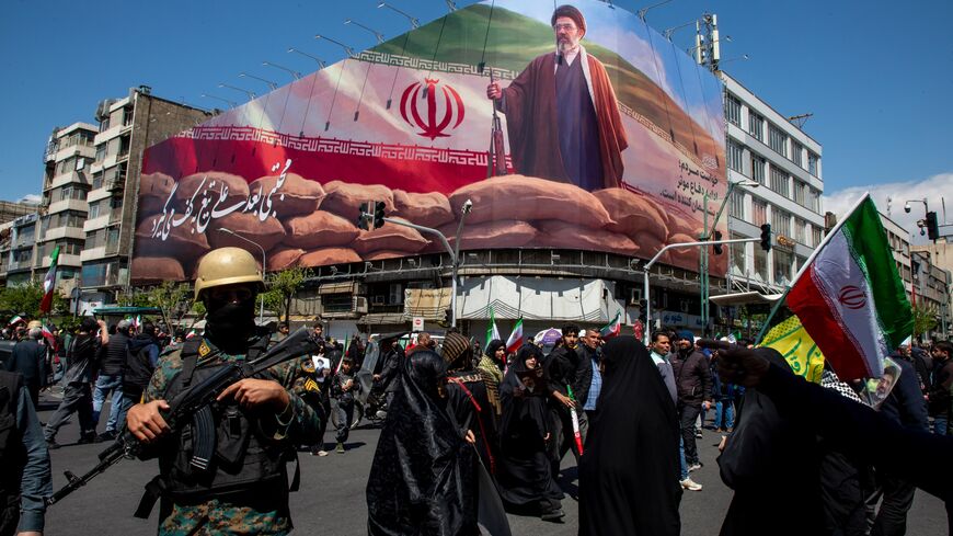 People gather under a large portrait of Iran's new Supreme Leader, Mojtaba Khamenei, during a memorial to mark the 40th day since his father, Ali Ayatollah Khamenei, was killed in US-Israeli joint strikes, on April 9, 2026, in Tehran, Iran.