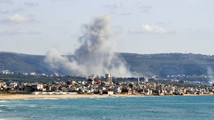 This photograph taken from the southern Lebanese area of Tyre shows smoke as it rises from the site of an Israeli airstrike that targeted the village of Qlaileh on April 13, 2026.