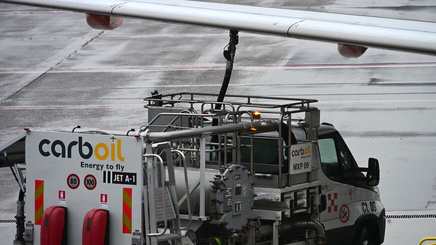 A fuel truck CarbOil services an Easyjet aircraft at Milan's Malpensa Airport on April 13, 2026. 