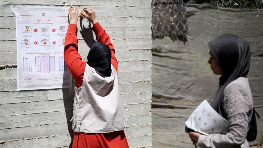 An elections employee tapes a poster with instructions to voters ahead of the upcoming municipal elections in Deir al-Balah in the central Gaza Strip on April 21, 2026.