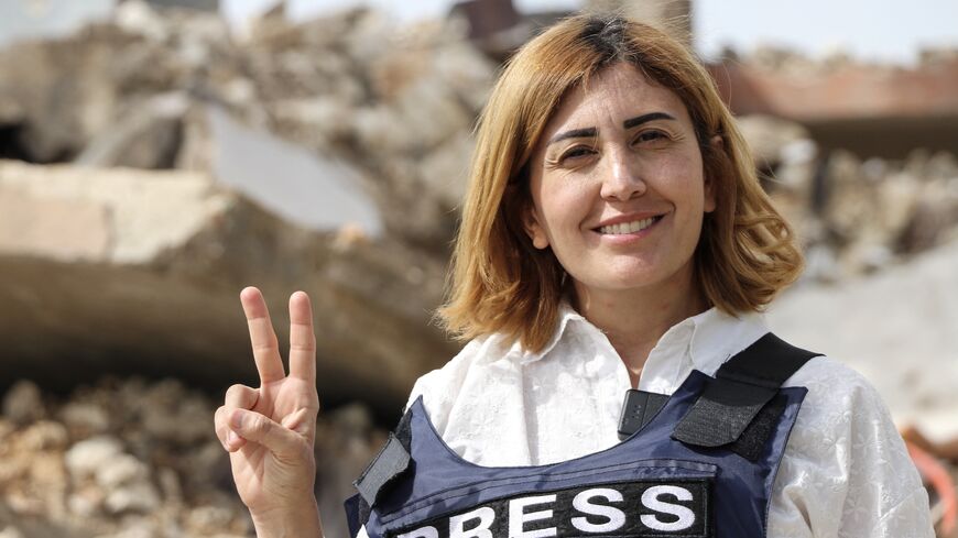 Amal Khalil, a veteran correspondent for the daily newspaper Al-Akhbar, in the southern Lebanese border village of Jebbayn in 2024.