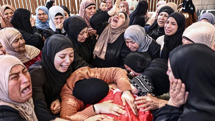 Palestinians mourned the deaths of Aws Hamdi al-Naasan, 14, and Jihad Marzouq Abu Naim, 32, who they said were killed in a settler attack on a school in the West Bank village of Al-Mughayir