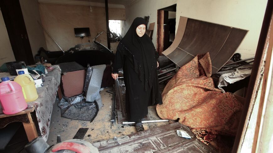 Outside her gutted home in southern Lebanon's Nabatieh, Zainab Farran keeps her clothes packed in a car in case the temporary truce between Hezbollah and Israel does not last