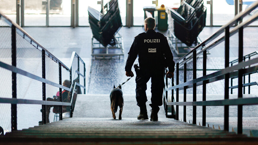 A police officer walks with a K9 unit as police present security measures ahead of the Eurovision Song Contest in Vienna, Austria, April 29, 2026. REUTERS/Lisa Leutner