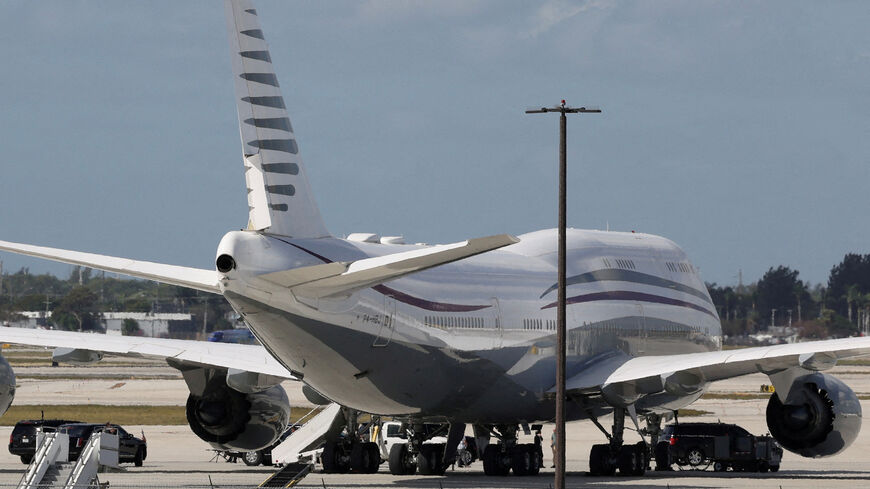 FILE PHOTO: The motorcade of U.S. President Donald Trump is parked next to a 12-year-old Qatari-owned Boeing 747-8 that Trump was touring in West Palm Beach, Florida, U.S., February 15, 2025. REUTERS/Kevin Lamarque/File Photo