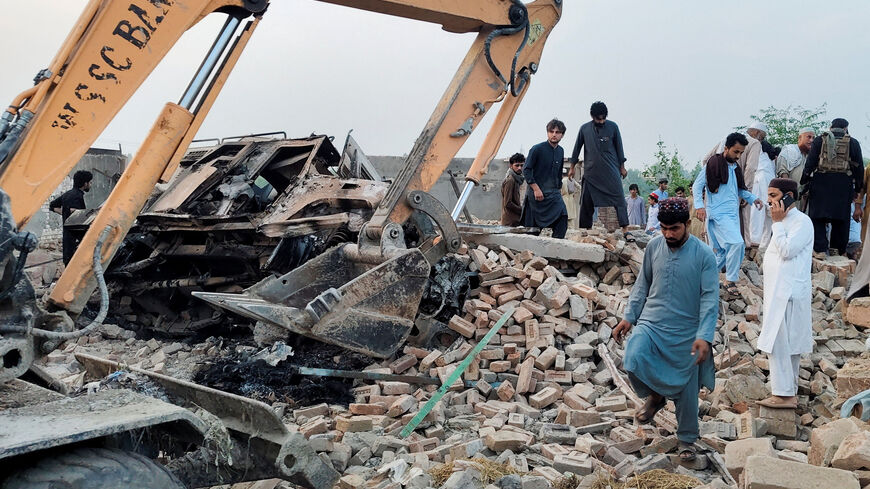 Residents gather on the rubble of a damaged police post after a car bombing in Bannu, Khyber Pakhtunkhwa province, Pakistan May 10, 2026. Picture taken with a mobile phone. REUTERS/Ehsan Khattak