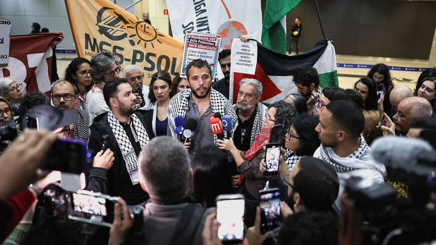 Brazilian activist Thiago Avila, who was detained aboard the Gaza-bound Global Sumud Flotilla, which was intercepted by Israeli forces, speaks to the media upon arrival at Sao Paulo/Guarulhos International Airport after being deported, in Guarulhos, Brazil, May 11, 2026. REUTERS/Amanda Perobelli