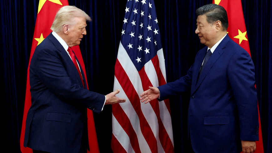 FILE PHOTO: FILE PHOTO: U.S. President Donald Trump shakes hands with Chinese President Xi Jinping as they hold a bilateral meeting at Gimhae International Airport, on the sidelines of the Asia-Pacific Economic Cooperation (APEC) summit, in Busan, South Korea, October 30, 2025. REUTERS/Evelyn Hockstein/File Photo/File Photo