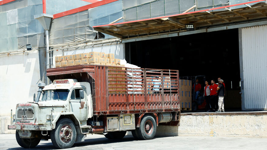 Workers load aid boxes onto a truck at a World Food Programme (WFP) facility in Damascus countryside, Syria, July 29, 2025. REUTERS/Yamam Alshaar