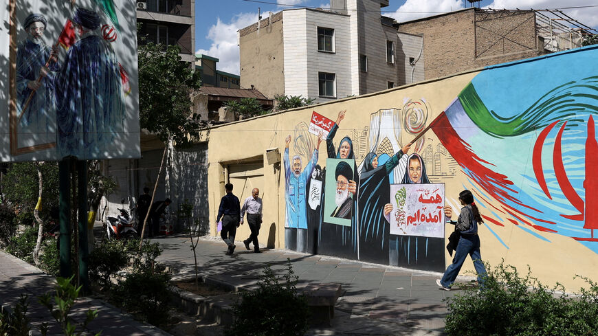 People walk on a street near a mural featuring an image of the late Supreme Leader of Iran, Ayatollah Ali Khamenei, in Tehran, Iran, May 18, 2026. Majid Asgaripour/WANA (West Asia News Agency) via REUTERS