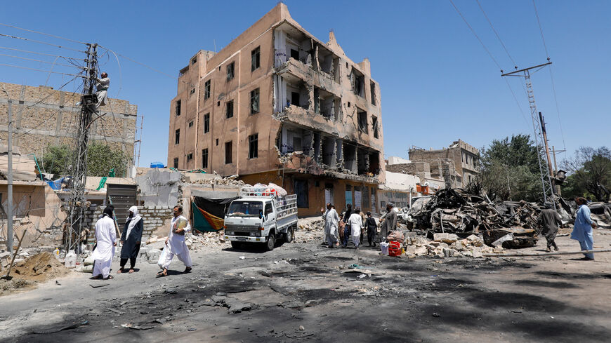 Residents walk past a damaged building, rubble and destroyed cars a day after a blast in Quetta, Pakistan May 25, 2026. REUTERS/Naseer Ahmed
