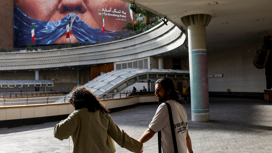 FILE PHOTO: People walk past an anti-U.S. billboard depicting U.S. President Donald Trump and the Strait of Hormuz, in Tehran, Iran, May 17, 2026. Majid Asgaripour/WANA (West Asia News Agency) via REUTERS/File Photo