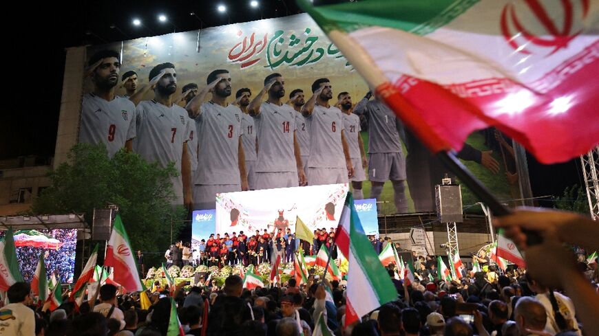 Iranians waved flags and cheered at a politically charged World Cup send-off for the national football team