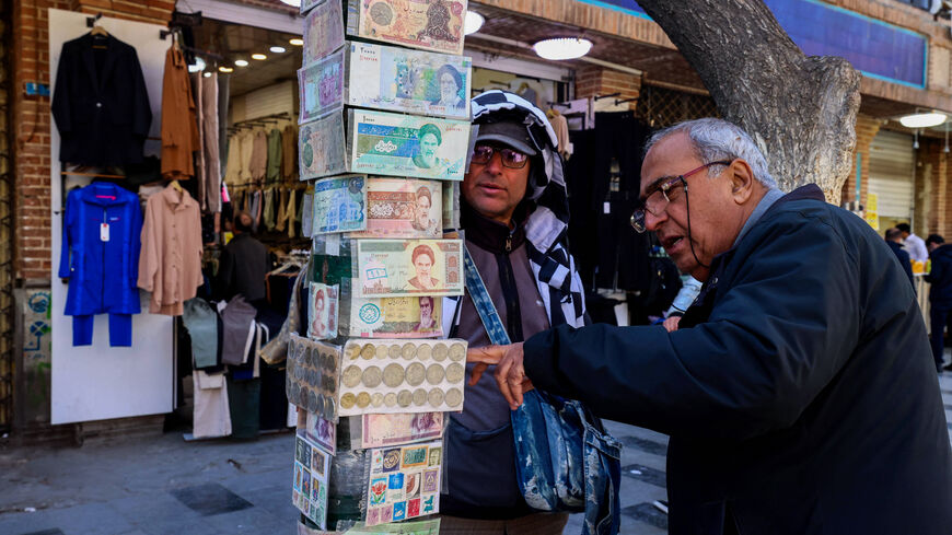 A man checks old banknotes in the Grand Bazaar in Tehran on March 3, 2025. 