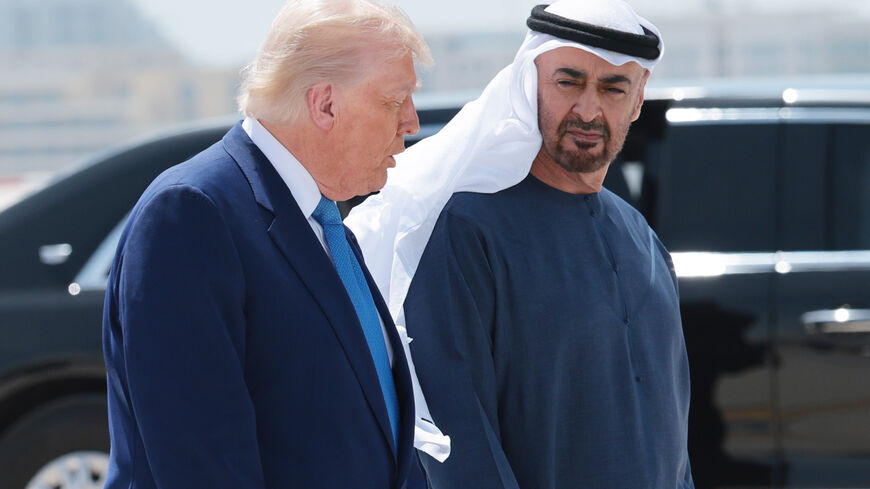 US President Donald Trump talks to UAE President Sheikh Mohamed bin Zayed Al Nahyan as he departs the Al Bateen Executive Airport on May 15, 2025, in Abu Dhabi, United Arab Emirates. 