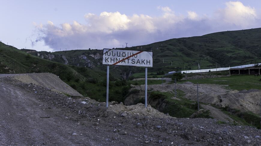A roadside sign marks the entrance to Khnatsakh on May 16, 2025, a border village in Armenia's Syunik Province that has become a frontline community amid rising tensions with Azerbaijan. 