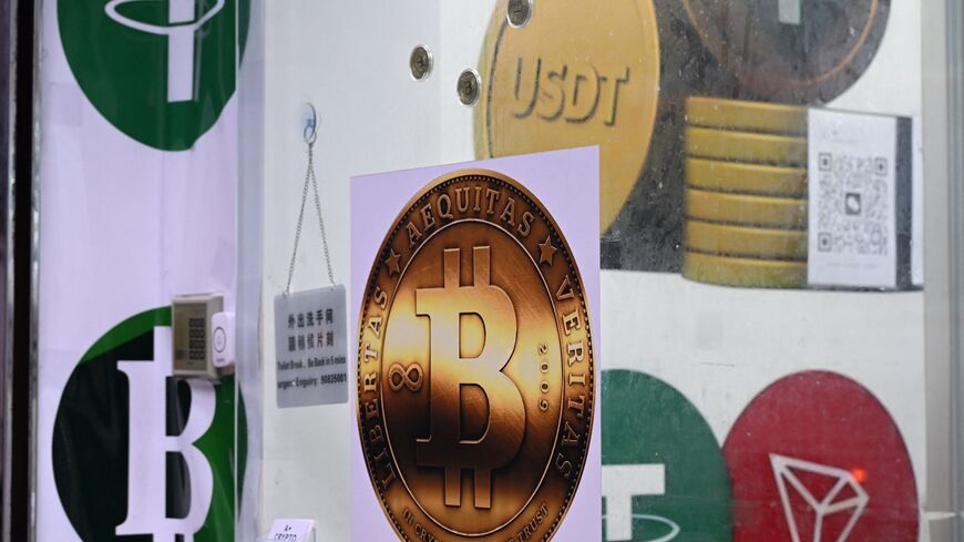 The symbols of bitcoin and the stablecoin Tether (USDT) are displayed at a cryptocurrency store in Hong Kong on July 29, 2025. 