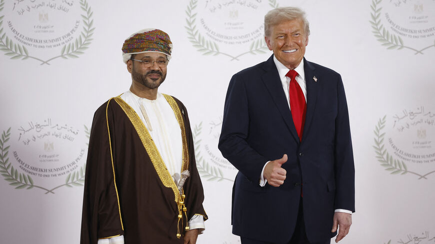Oman's Foreign Minister Sayyid Badr Albusaidi (L) and US President Donald Trump pose during a summit on Gaza in Sharm el-Sheikh on October 13, 2025. 