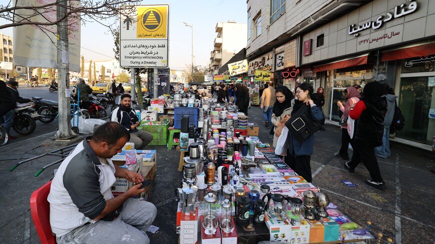 Women shop from a street vendor at Enghelab Square in the capital Tehran on Nov. 11, 2025. 