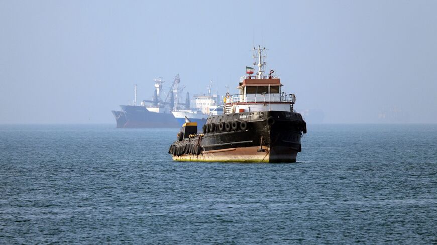 In this picture obtained from Iran's ISNA news agency on May 4, 2026, the Iran-flagged tugboat Basim sails near a ship anchored in the Strait of Hormuz off Bandar Abbas in southern Iran. 