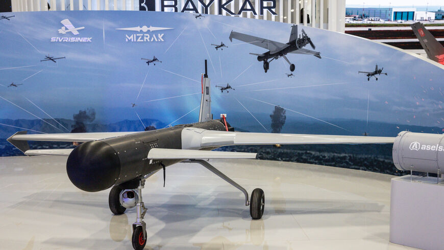 People look at a drone on display at the Baykar exhibit at the SAHA International Defence and Aerospace Expo on May 06, 2026 in Istanbul, Turkey. 