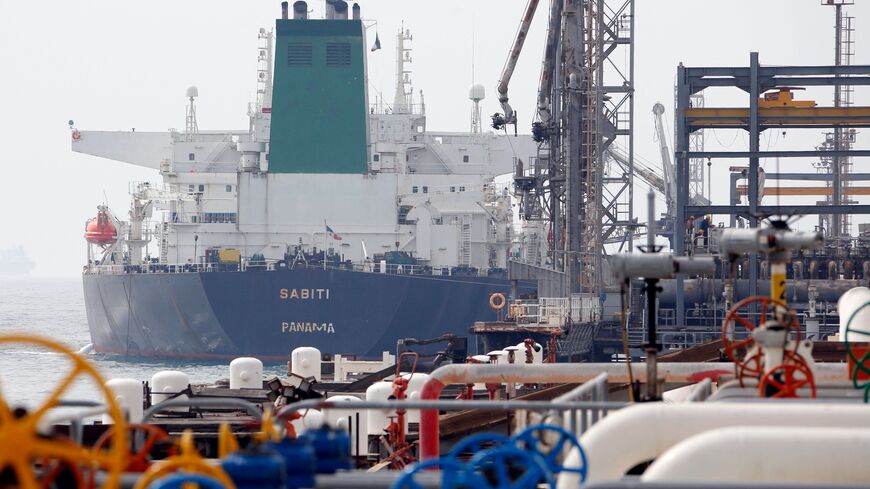 A picture taken on March 12, 2017, shows an Panamanian tanker docking at the platform of the oil facility in the Khark Island, on the shore of the Gulf. 