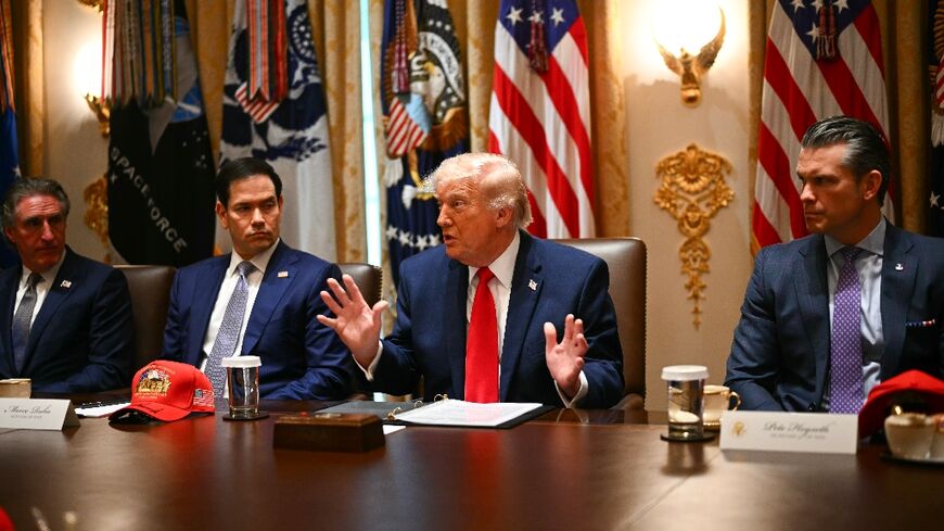 US Secretary of the Interior Doug Burgum (L), US Secretary of State Marco Rubio (2nd L) and US Defense Secretary Pete Hegseth (R) listen to US President Donald Trump (C) weigh options on Iran in a cabinet meeting