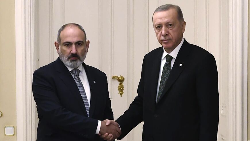 Turkey’s President Recep Tayyip Erdogan, right, and Armenia’s Prime Minister Nikol Pashinyan shake hands before a meeting at Prague Castle in Prague, Czech Republic, Thursday, Oct. 6, 2022.