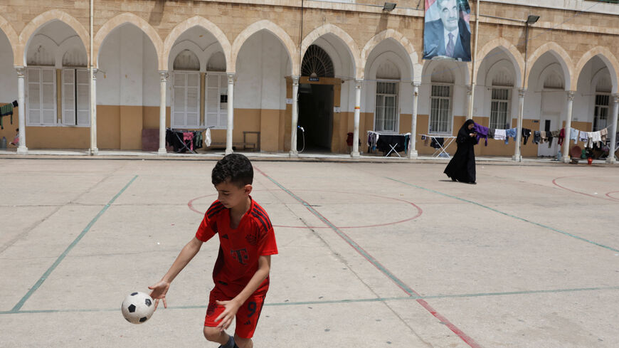 A child plays in the yard of a school used as a temporary shelter for displaced people, in Beirut, Lebanon, May 2, 2026. REUTERS/ Raghed Waked