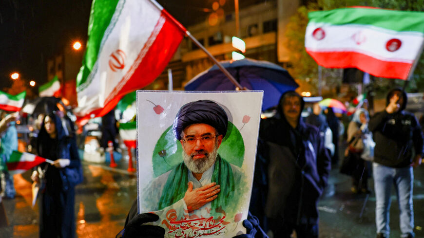 A woman holds a poster depicting Iran’s new Supreme Leader Mojtaba Khamenei during an anti-U.S. and anti-Israeli rally, amid the U.S.-Israeli conflict with Iran, in Tehran, Iran, March 26, 2026. Majid Asgaripour/WANA (West Asia News Agency) via REUTERS