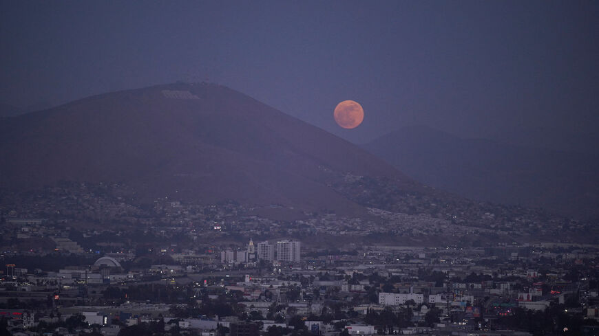 The moon rises over Tijuana as the Iranian national soccer team is set to establish its base camp for the FIFA World Cup 2026 in the Mexican border city after Mexico’s President Claudia Sheinbaum agreed to host the squad, following reports that the U.S. government did not want Iran to remain at its original base in Arizona during the tournament, in Tijuana, Mexico, May 30, 2026. REUTERS/Victor Medina
