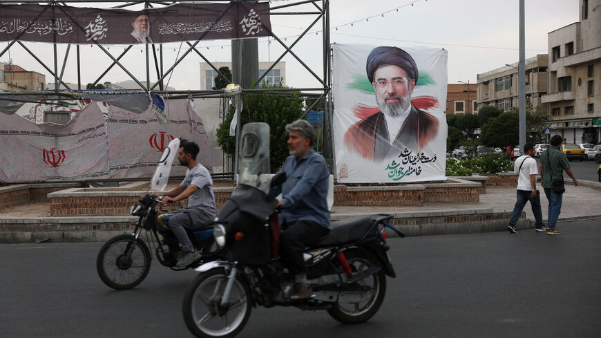 People ride near a banner with an image of Iran's Supreme Leader, Mojtaba Khamenei, on a street in Tehran, Iran June 7, 2026. Majid Asgaripour/WANA (West Asia News Agency) via REUTERS