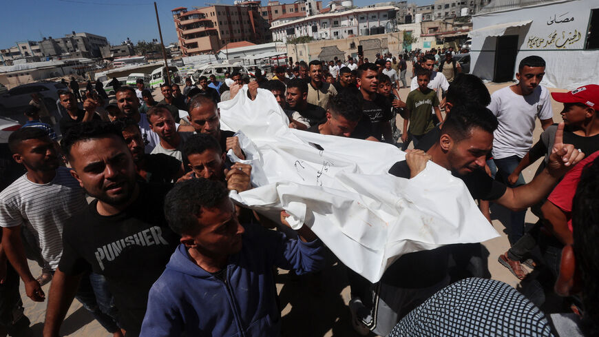 Palestinians carry a body outside the Nasser hospital following an Israeli strike on a police station, in Khan Younis in the southern Gaza Strip, June 7, 2026, REUTERS/Ramadan Abed