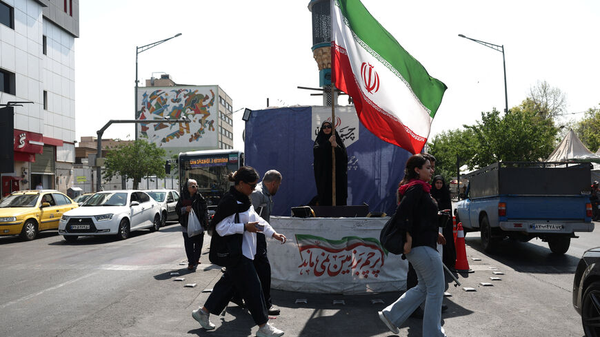 A woman holds an Iranian flag on a street in Tehran, Iran, June 10, 2026. Majid Asgaripour/WANA (West Asia News Agency) via REUTERS