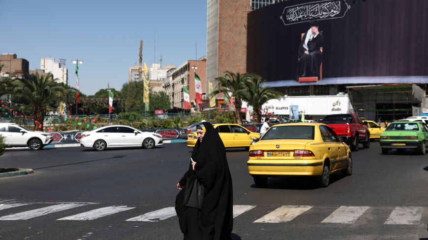 A woman walks past a billboard with a picture of the late Iran's Supreme Leader Ayatollah Ali Khamenei, after U.S. and Iranian officials said they had reached a deal to end their war and reopen the Strait of Hormuz, in Tehran, Iran, June 15, 2026. Majid Asgaripour/WANA (West Asia News Agency) via REUTERS
