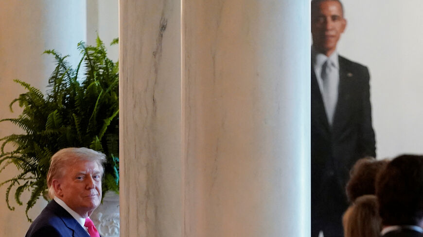 FILE PHOTO: U.S. President Donald Trump looks on as the portrait of former U.S. President Barack Obama can be seen in the background at the White House in Washington, DC., U.S., June 26, 2025. REUTERS/Nathan Howard/ File Photo