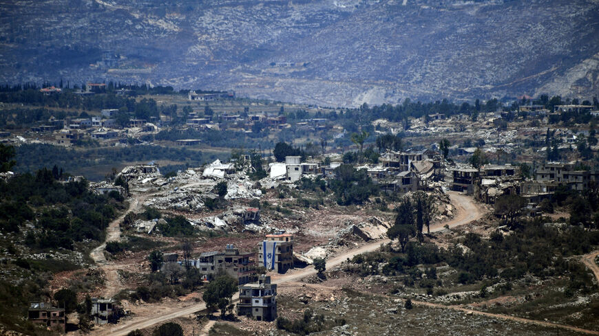 An Israeli flag hangs from a damaged building in a village inside south Lebanon close to the border as seen from northern Israel, June 18, 2026. REUTERS/Gil Eliyahu