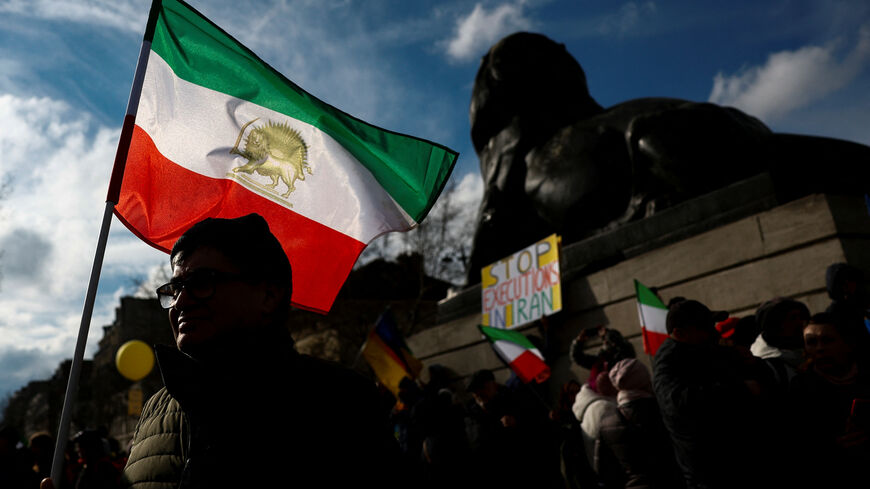 FILE PHOTO: A man holds a flag during a protest by supporters of Iranian opposition group National Council of Resistance of Iran (NCRI), in Paris, France, February 8, 2025. REUTERS/Gonzalo Fuentes/File Photo