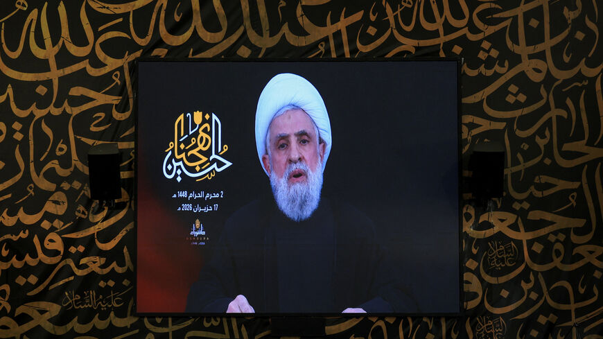 Hezbollah chief Naim Qassem delivers a televised speech on a giant screen at the burial site of former Hezbollah leader Hassan Nasrallah, on the outskirts of Beirut, Lebanon, June 17, 2026. REUTERS/Mohamed Azakir
