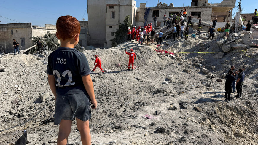 A child stands next to the rubble of a building damaged in an Israeli strike in Qennarit, southern Lebanon, June 20, 2026. Picture taken with a mobile phone. REUTERS/Stringer