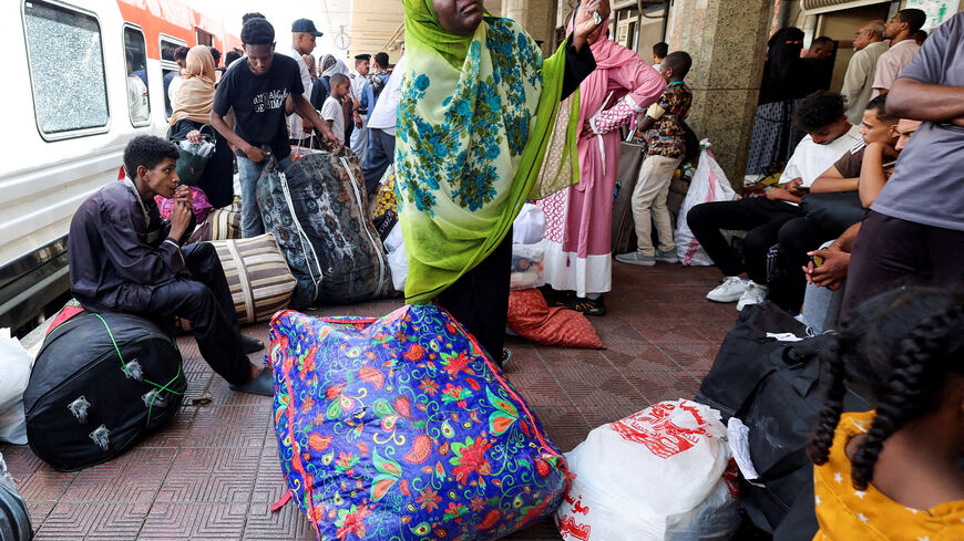 FILE PHOTO: People gather at a train station, as Sudanese refugees crowd at Cairo?s main station to board a free train with a voluntary return coordinated by the Egyptian government to Aswan, where buses will take them home to Khartoum, in Cairo, Egypt July 28, 2025. REUTERS/Amr Abdallah Dalsh/File Photo