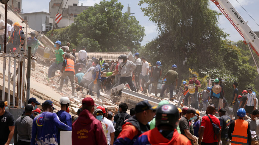 People search for casualties amid the rubble of a collapsed building, in the aftermath of earthquakes in Caracas, Venezuela, June 25, 2026. REUTERS/Leonardo Fernandez Viloria