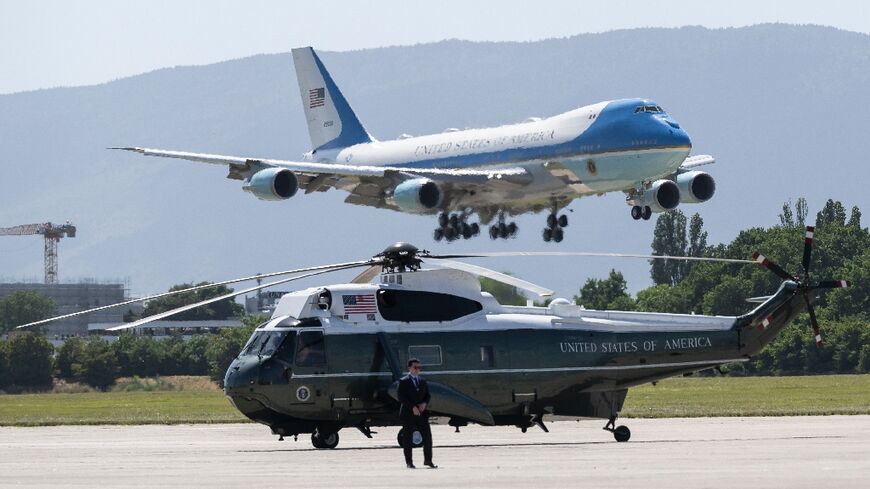 Air Force One carrying US President Donald Trump lands at the Geneva Airport with Marine One helicopter in the foreground ahead of the G7 summit
