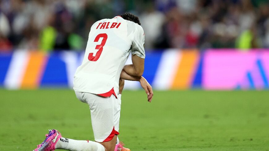 Tunisia's dejected players have already been knocked out of the World Cup after conceding nine goals in two matches