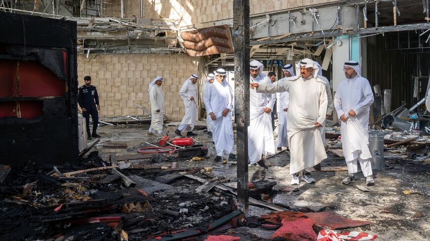 This handout photo from the Kuwaiti News Agency shows Kuwaiti Prime Minister Sheikh Ahmad al-Abdullah al-Sabah (2R) inspecting damage from an Iranian drone attack on the Kuwait City airport