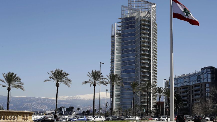 A picture shows the four seasons hotel in Beirut with the snow covered mountain of Sannine in the background on March 8, 2019. 