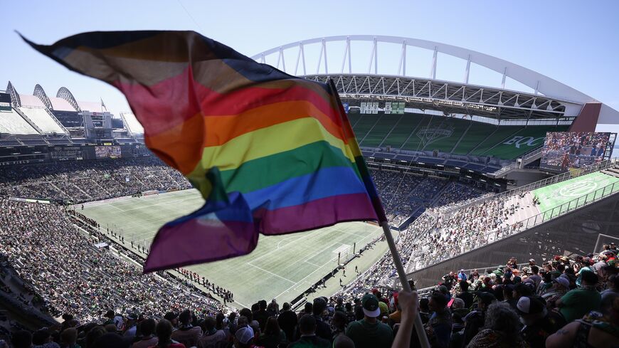 A fan waves a Pride flag before the game between the Seattle Sounders and the Portland Timbers at Lumen Field on June 3, 2023, in Seattle, Washington. 