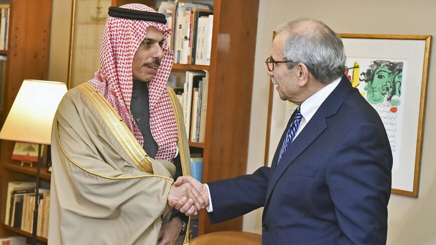 Lebanese Prime Minister-designate Nawaf Salam (R) shakes hands with Saudi Arabia's Foreign Minister Faisal bin Farhan before their meeting in Beirut on Jan. 23, 2025. 